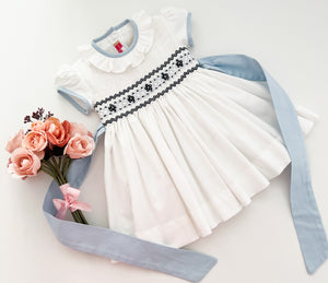 The hand smocked BENEDICTE dress - in white and blue